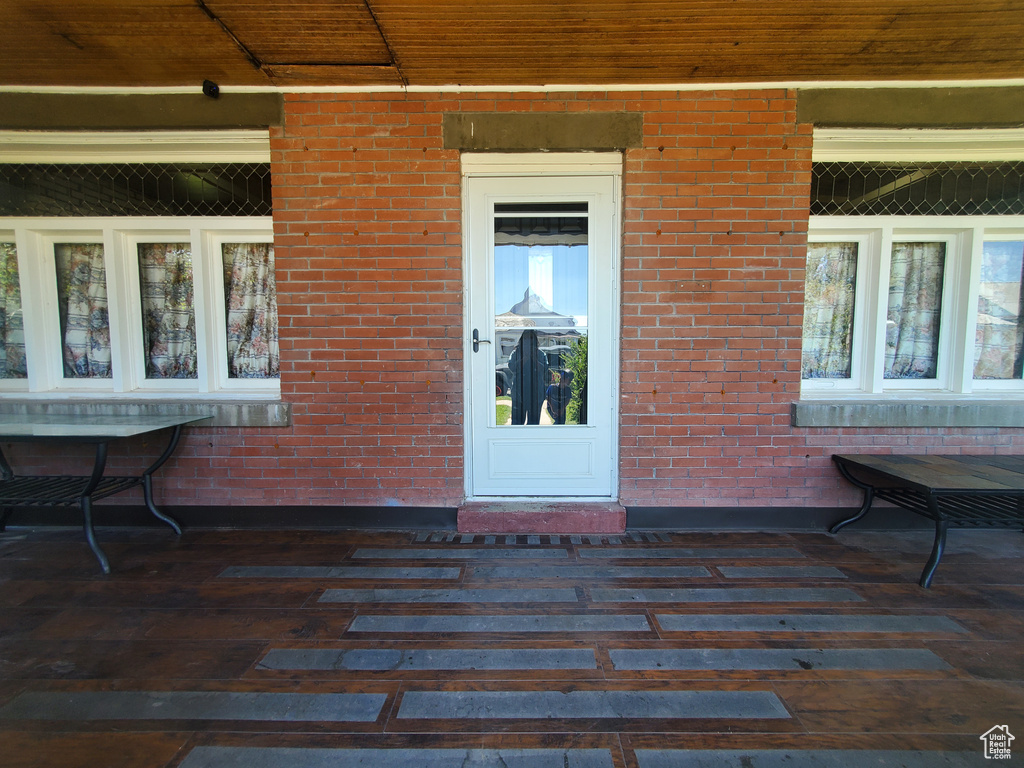 Entrance to property featuring brick siding