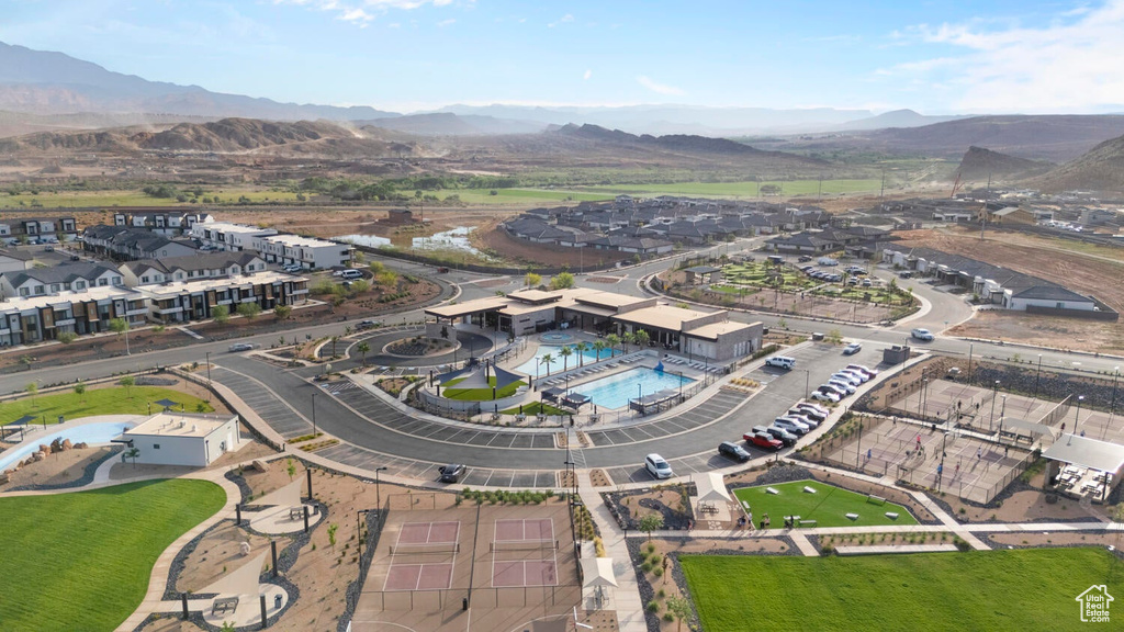Aerial view of property's location featuring a pool area and a mountainous background