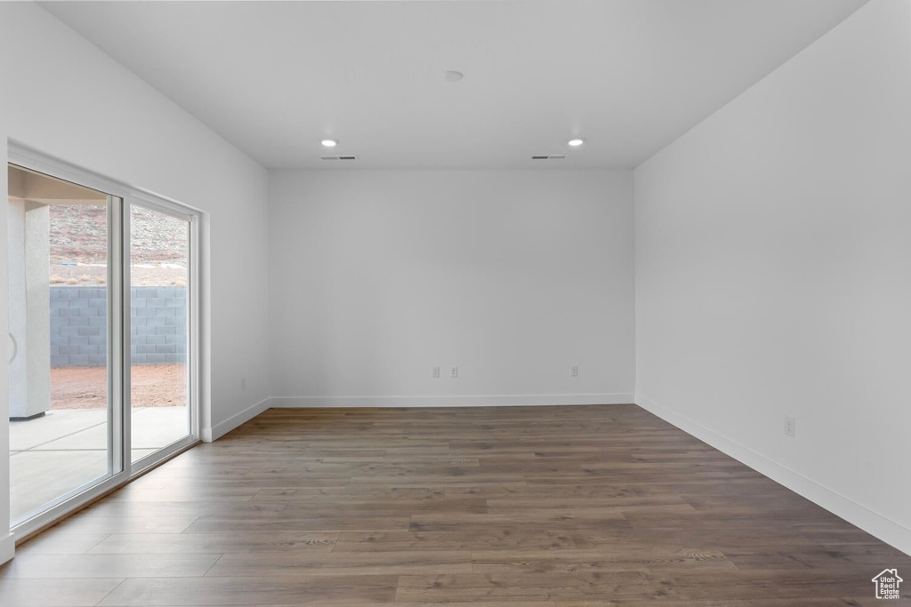 Spare room featuring recessed lighting and wood finished floors