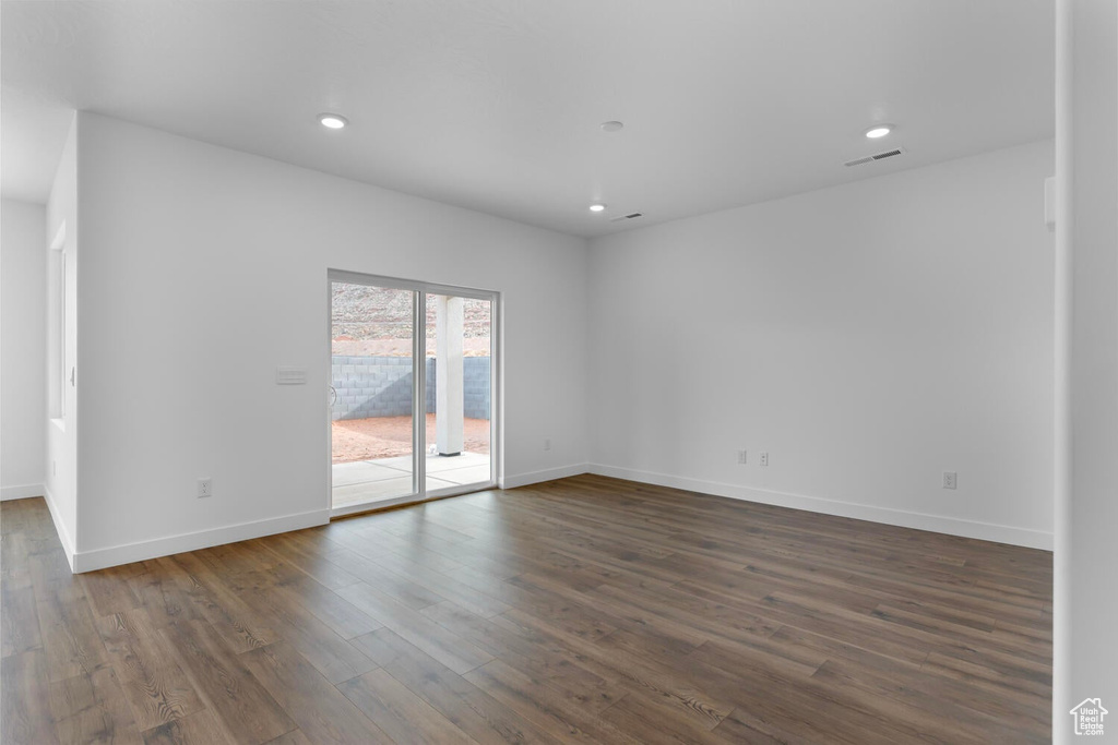 Unfurnished room featuring dark wood-style floors and recessed lighting