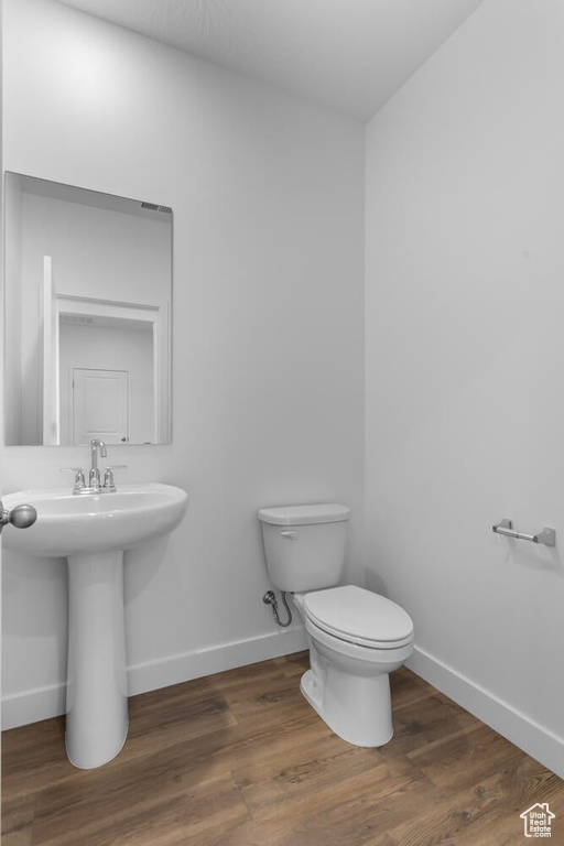 Half bath with wood finished floors