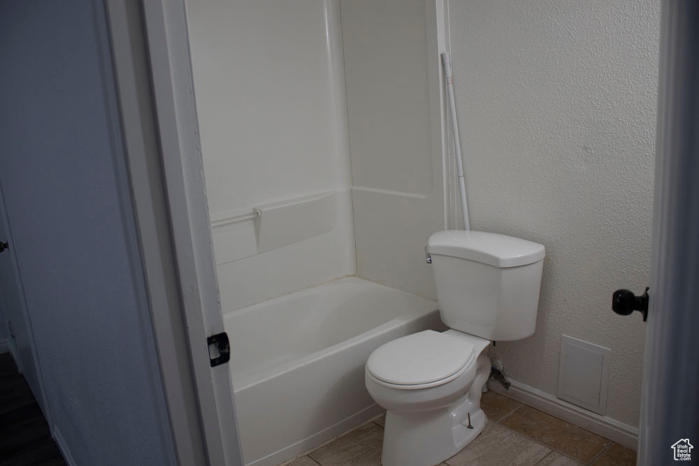 Bathroom with tile patterned flooring and tub / shower combination