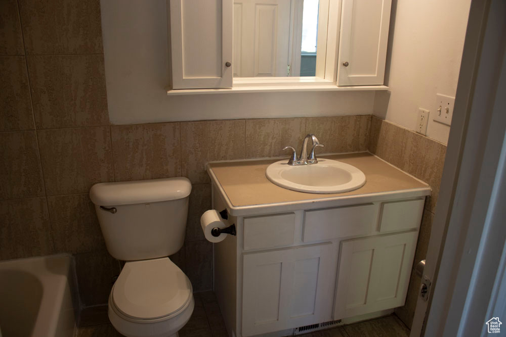 Full bathroom featuring vanity and a bathtub