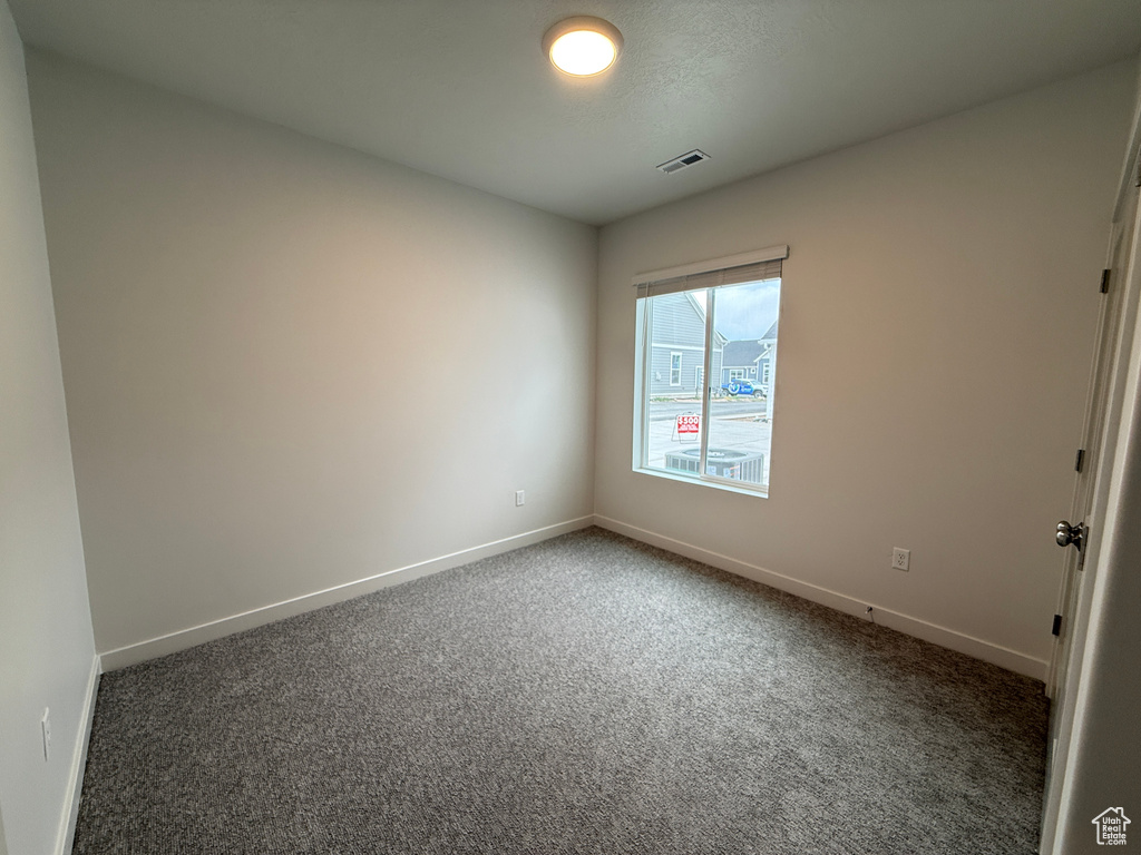 Carpeted empty room with baseboards