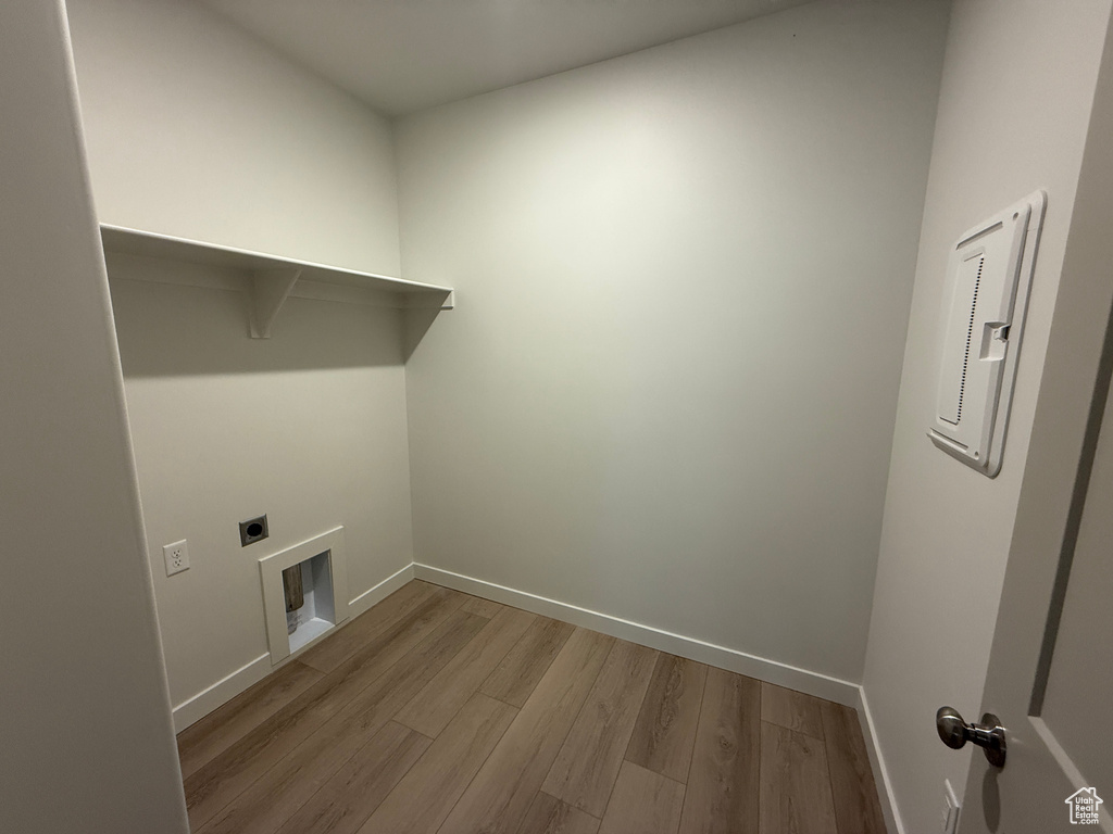 Washroom featuring electric dryer hookup, wood finished floors, and electric panel