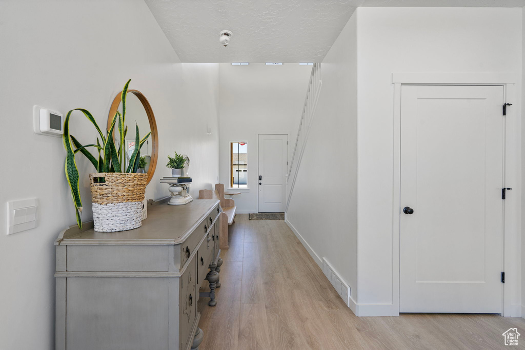 Foyer entrance featuring light wood-type flooring and baseboards