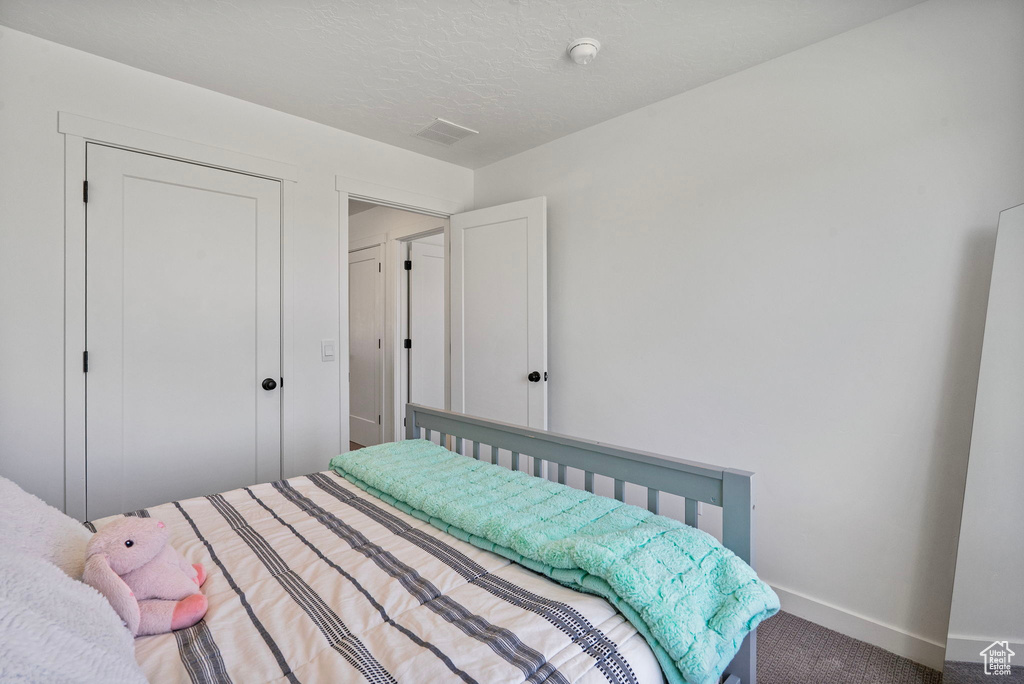 Carpeted bedroom featuring baseboards