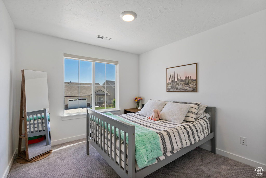 Carpeted bedroom with baseboards