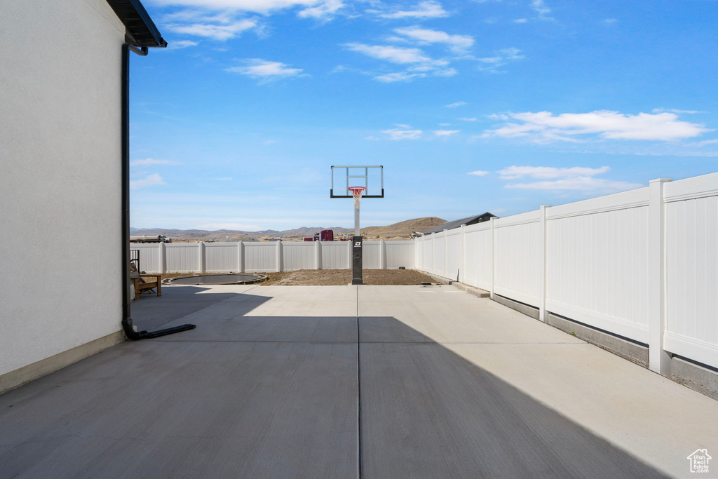 Fenced backyard featuring a mountain view