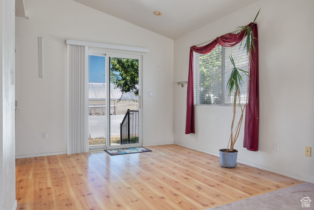 Entryway with lofted ceiling and wood finished floors
