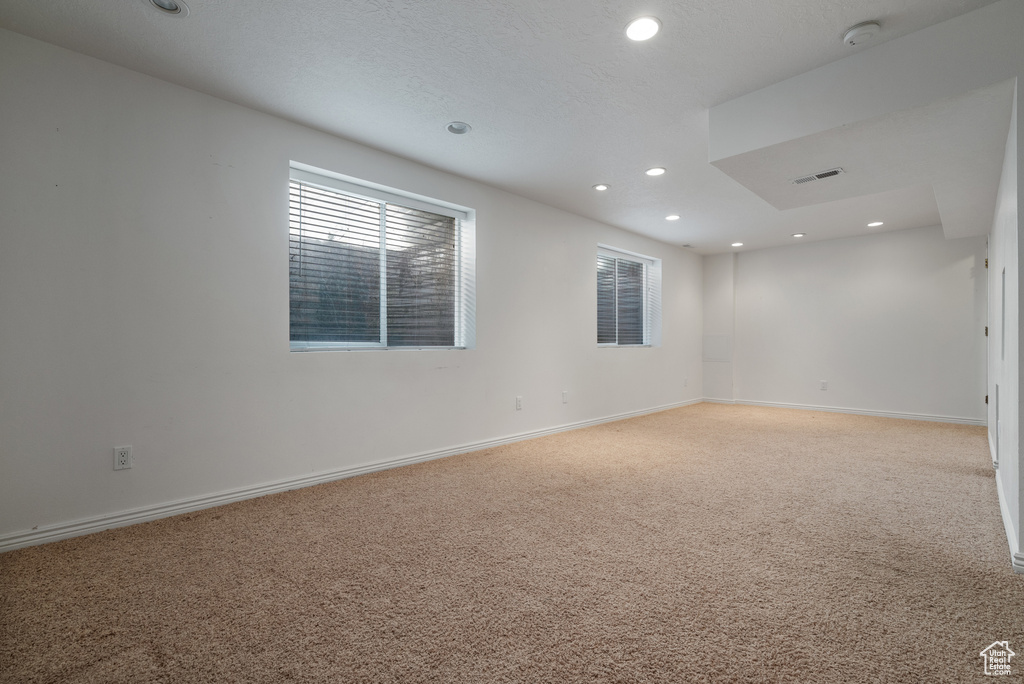 Spare room featuring recessed lighting and light carpet