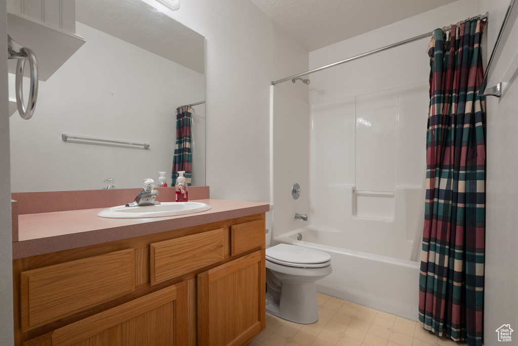 Full bath featuring shower / bath combo and vanity