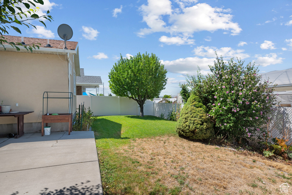 Fenced backyard featuring a patio
