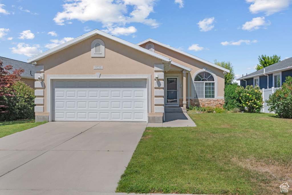 Ranch-style house with a front lawn, driveway, stucco siding, and a garage