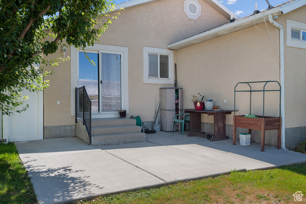 Back of house featuring stucco siding, a patio, and entry steps