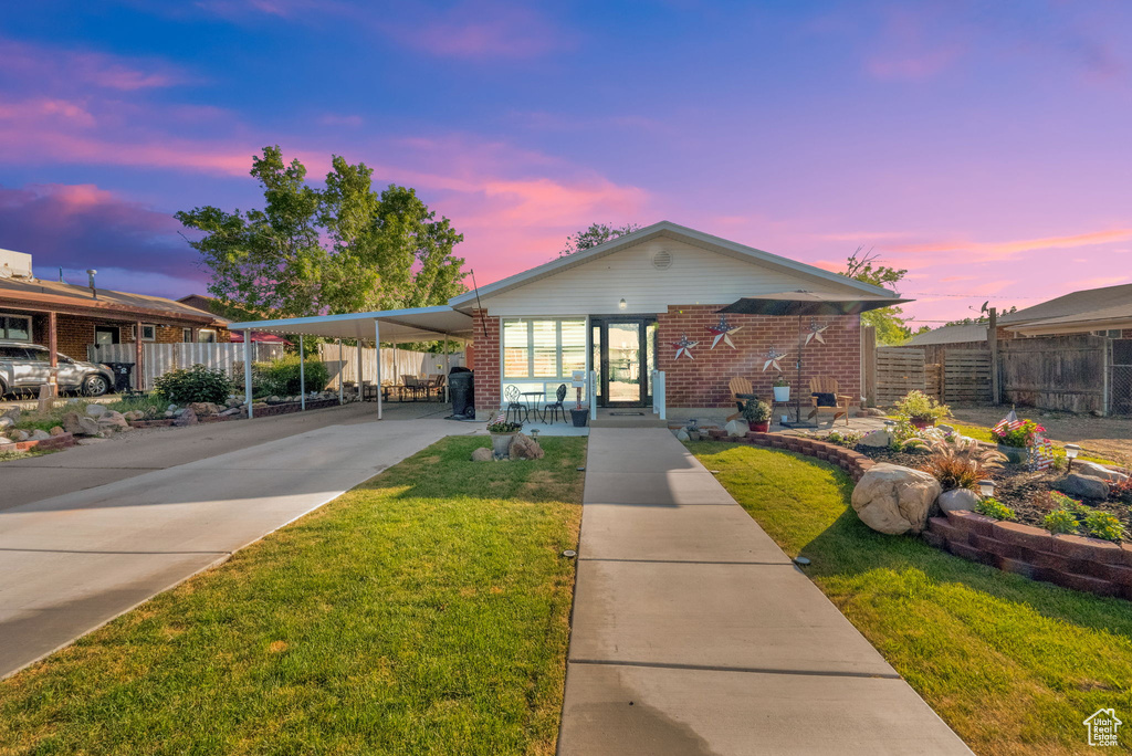 Ranch-style house with an attached carport, concrete driveway, and brick siding