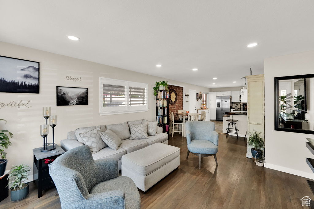 Living room with dark wood-style floors and recessed lighting
