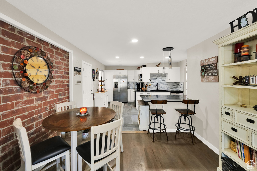 Dining room featuring dark wood-style flooring and recessed lighting