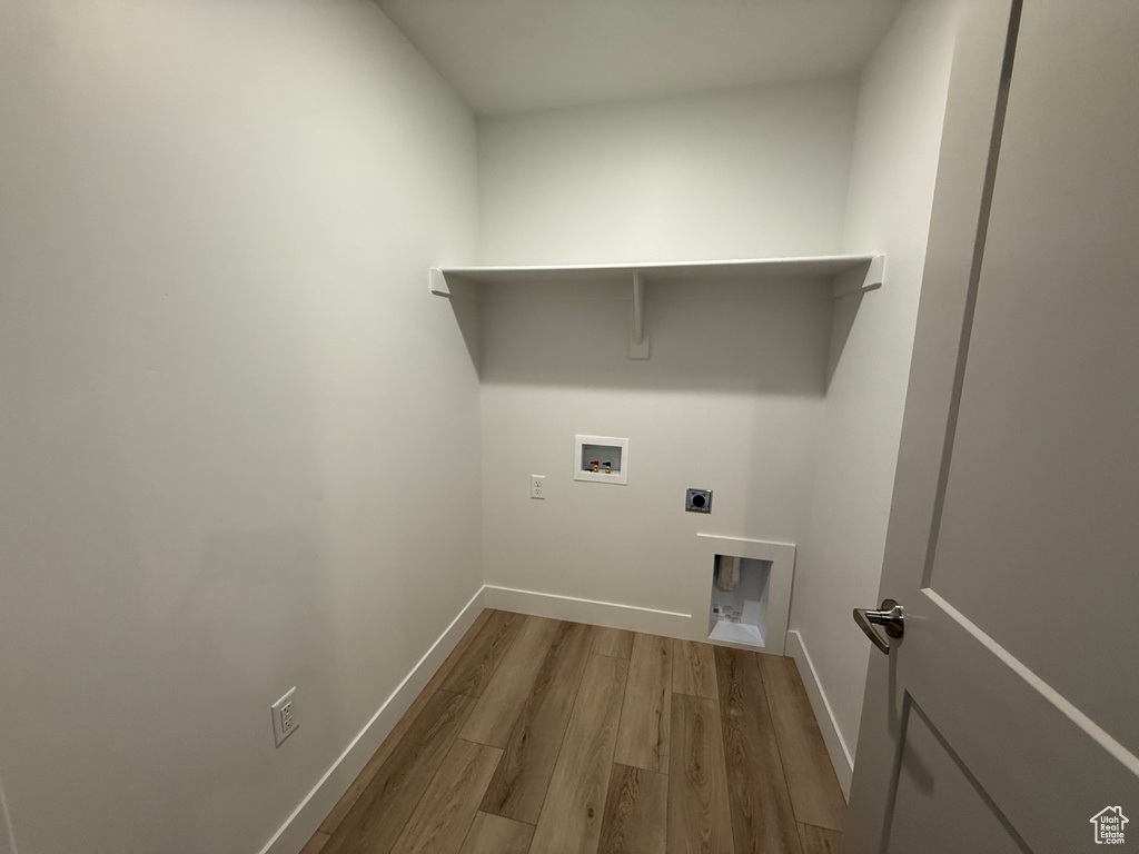 Washroom featuring wood finished floors, electric dryer hookup, and hookup for a washing machine