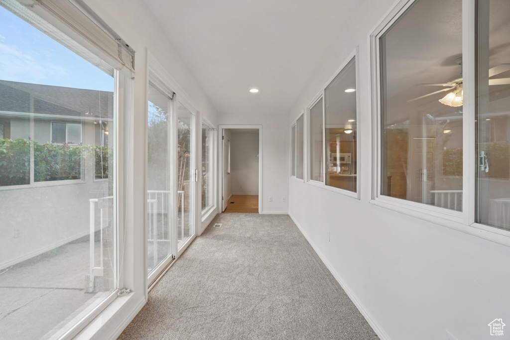 Unfurnished sunroom featuring carpet and recessed lighting