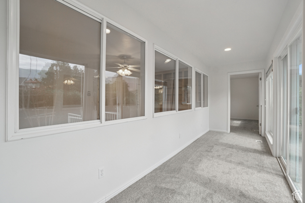 Unfurnished sunroom with carpet and recessed lighting
