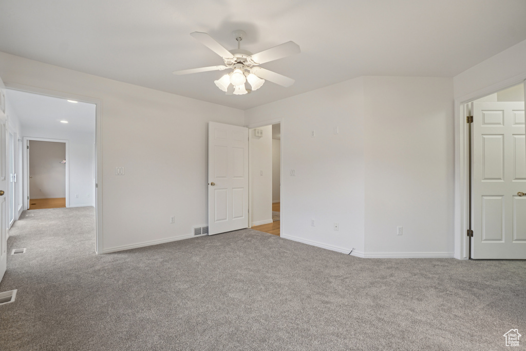 Unfurnished bedroom featuring light colored carpet and a ceiling fan