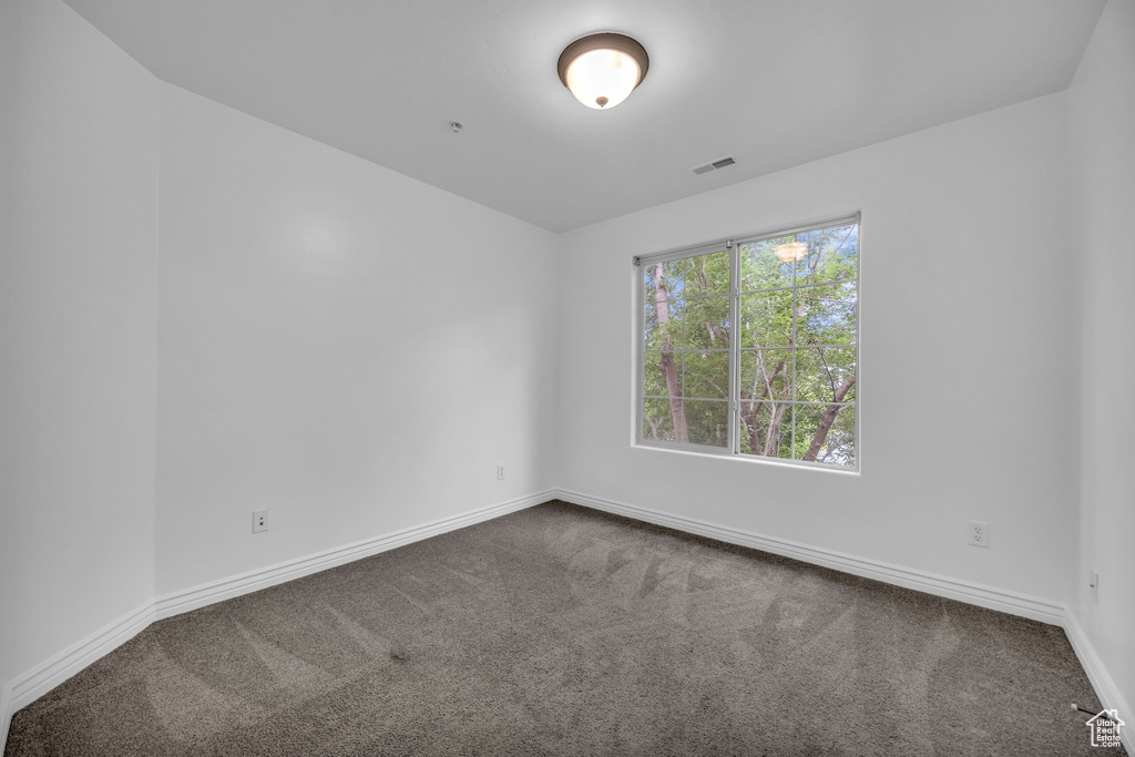 Spare room with carpet and baseboards