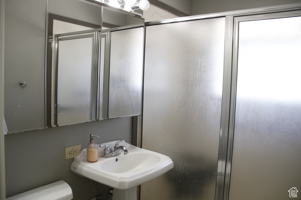 Full bathroom featuring toilet and a stall shower