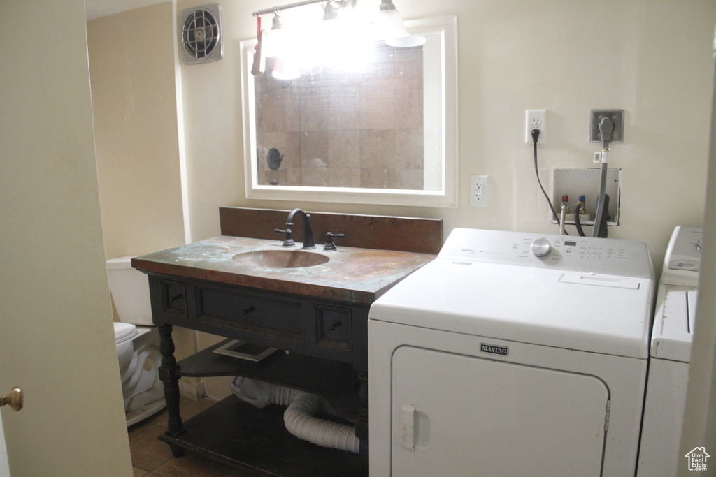 Washroom featuring washing machine and clothes dryer