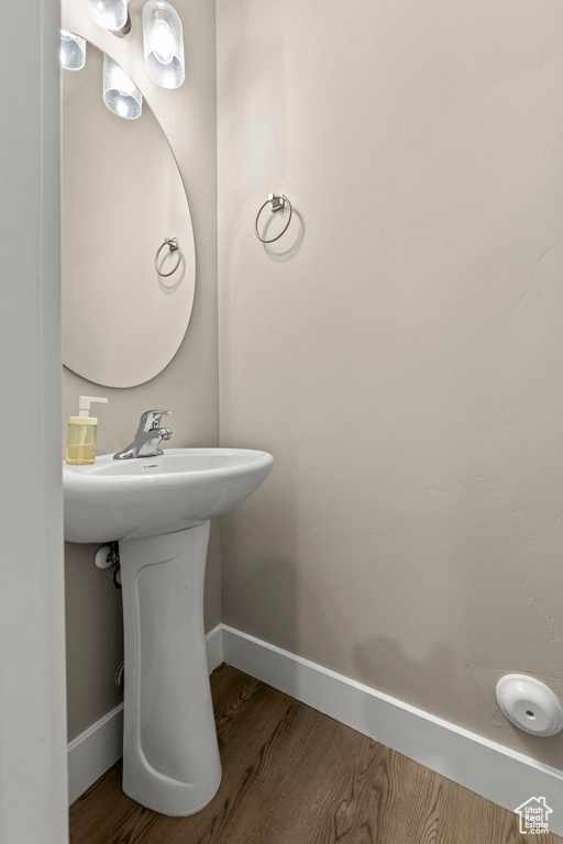 Bathroom with wood finished floors and baseboards