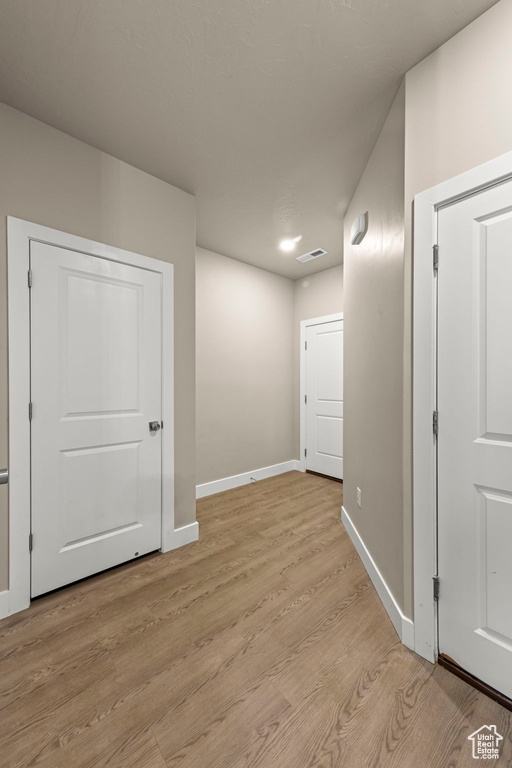 Unfurnished room featuring baseboards and light wood-style flooring