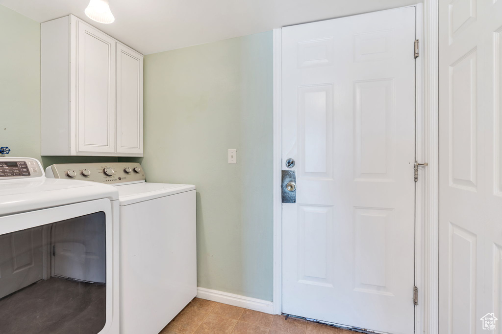 Washroom featuring washing machine and clothes dryer and cabinet space