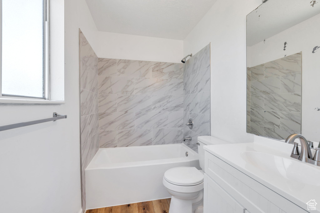 Full bathroom with vanity, tub / shower combination, and wood finished floors