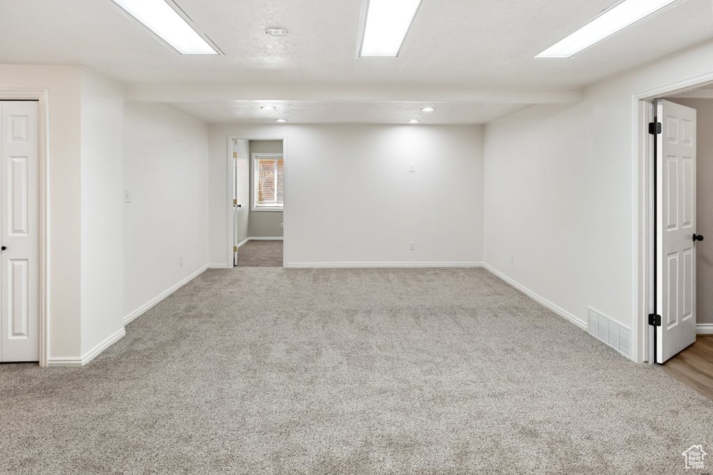 Below grade area with carpet flooring and recessed lighting