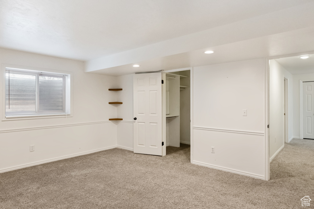 Unfurnished bedroom with carpet flooring, recessed lighting, and a walk in closet