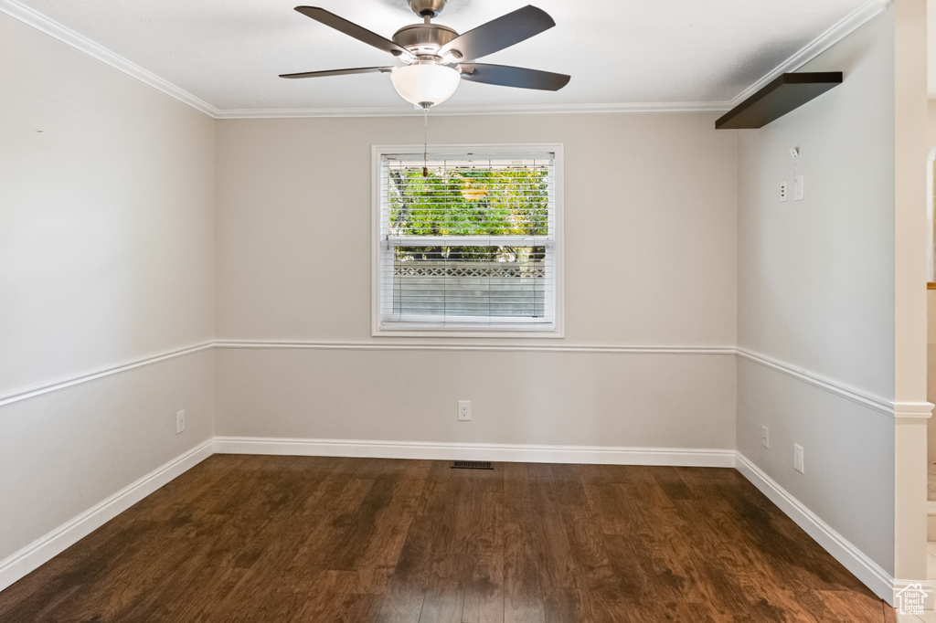 Spare room with wood finished floors, ceiling fan, and crown molding