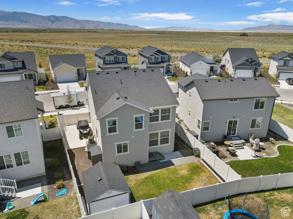 Aerial view of residential area featuring a mountainous background