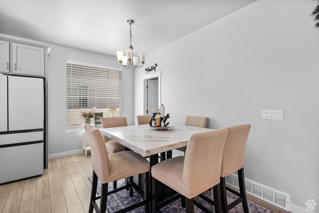 Dining space featuring a chandelier and light wood-style floors
