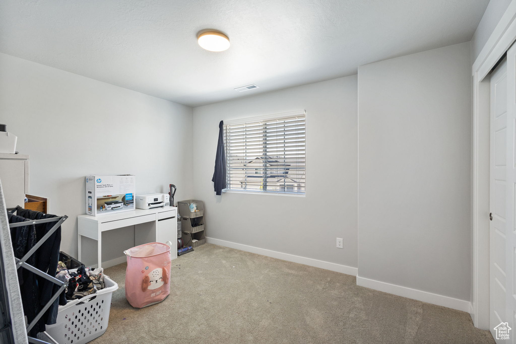 Carpeted office with baseboards