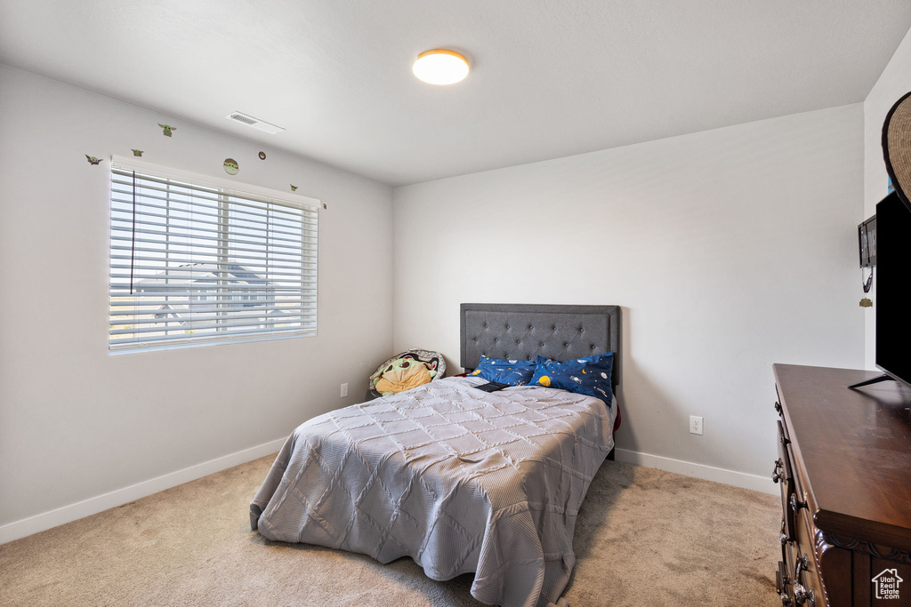 Bedroom with carpet flooring and baseboards