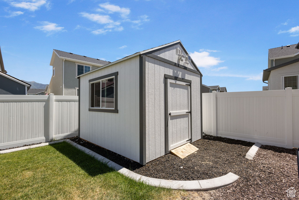 View of shed with a fenced backyard