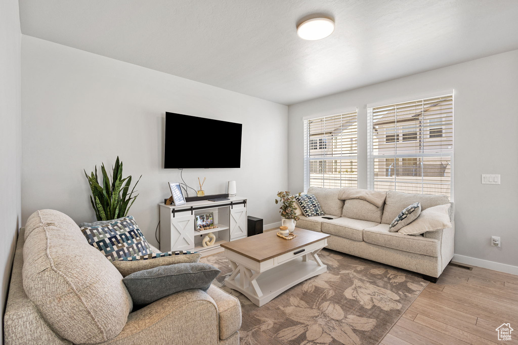 Living area featuring light wood-style floors and baseboards