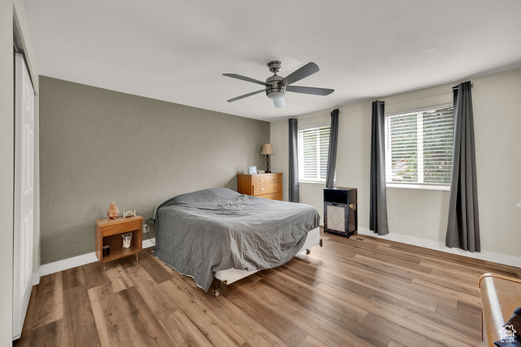 Bedroom featuring wood finished floors and a ceiling fan