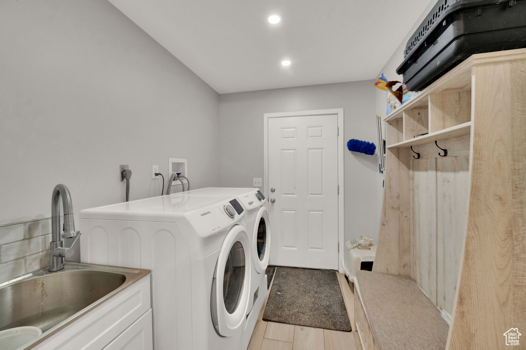 Washroom with separate washer and dryer and recessed lighting