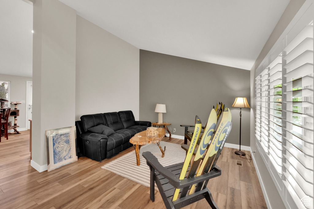 Living area featuring lofted ceiling and light wood-type flooring