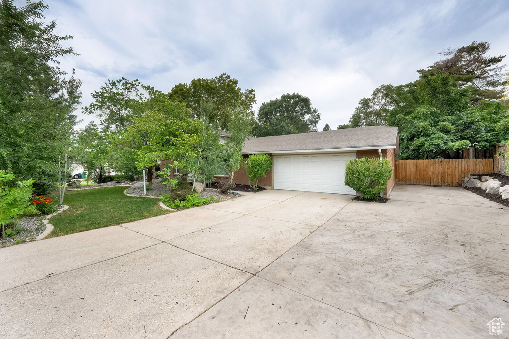 View of front of house featuring driveway and an attached garage