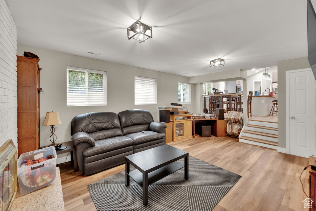 Living room with light wood-style floors and stairs