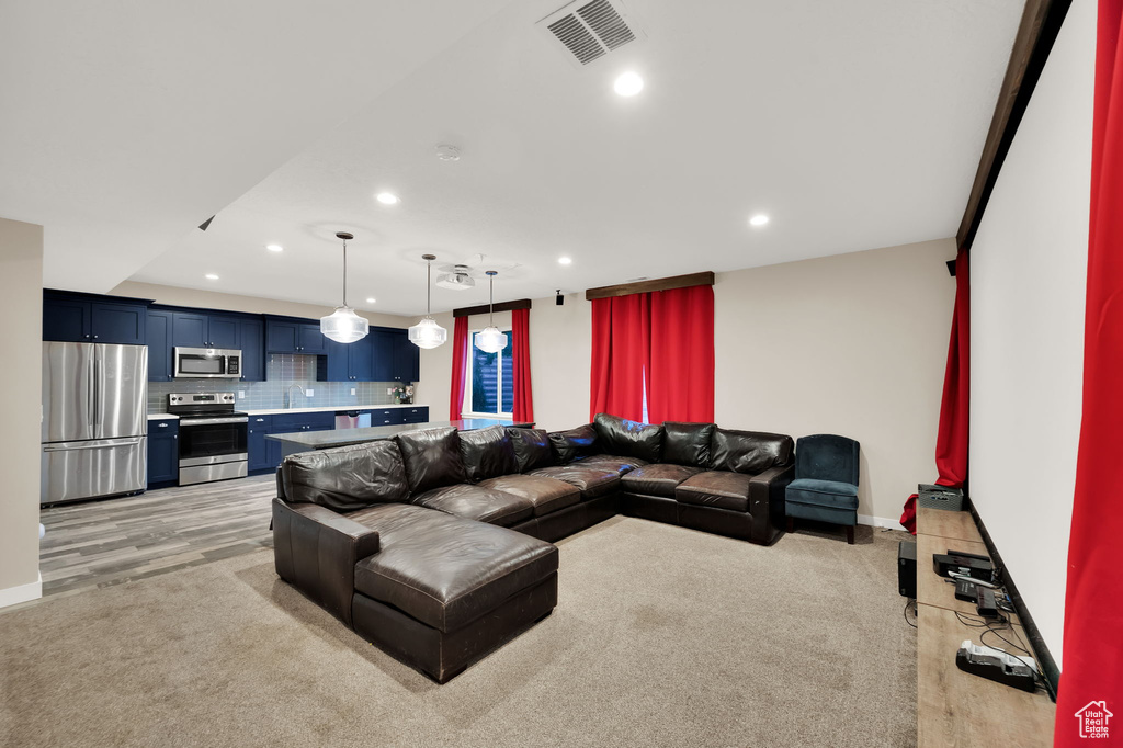 Living room with recessed lighting and light wood-style floors