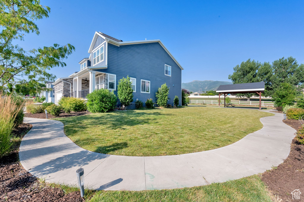 View of side of property with a gazebo and a mountain view