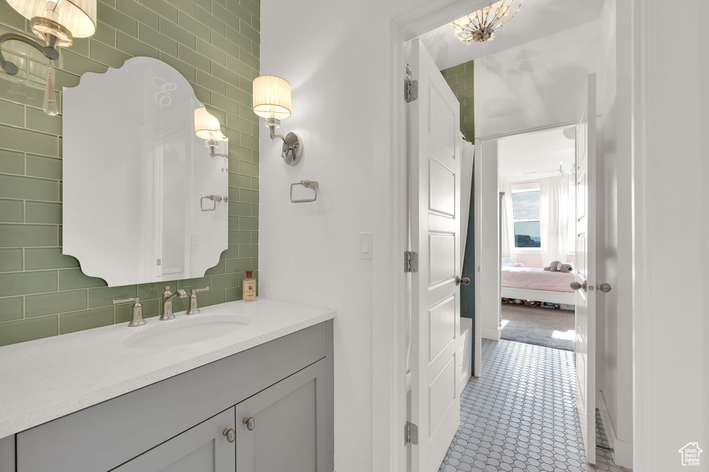 Ensuite bathroom with vanity and tile walls